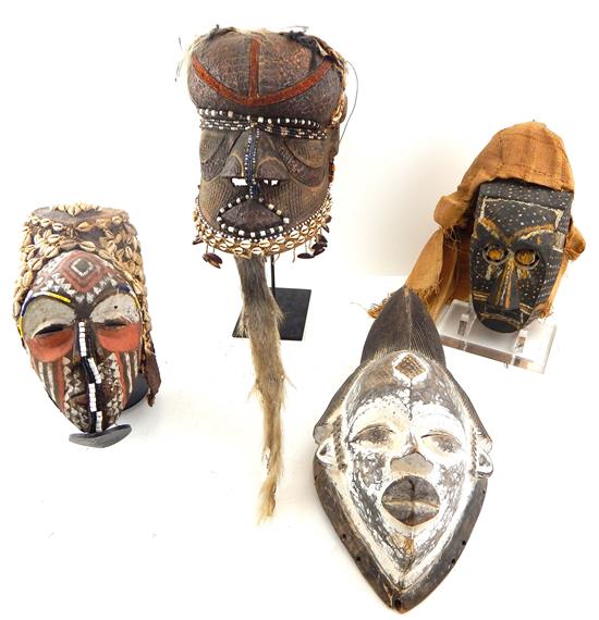 Appraisal: TRIBAL Four carved African masks three Kuba headdresses along with