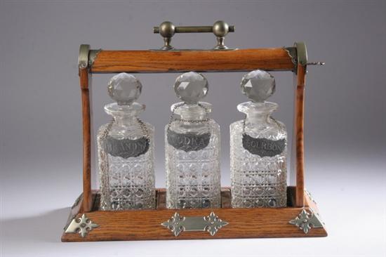 Appraisal: VICTORIAN BRASS-MOUNTED OAK TANTALUS WITH THREE CRYSTAL DECANTERS - in