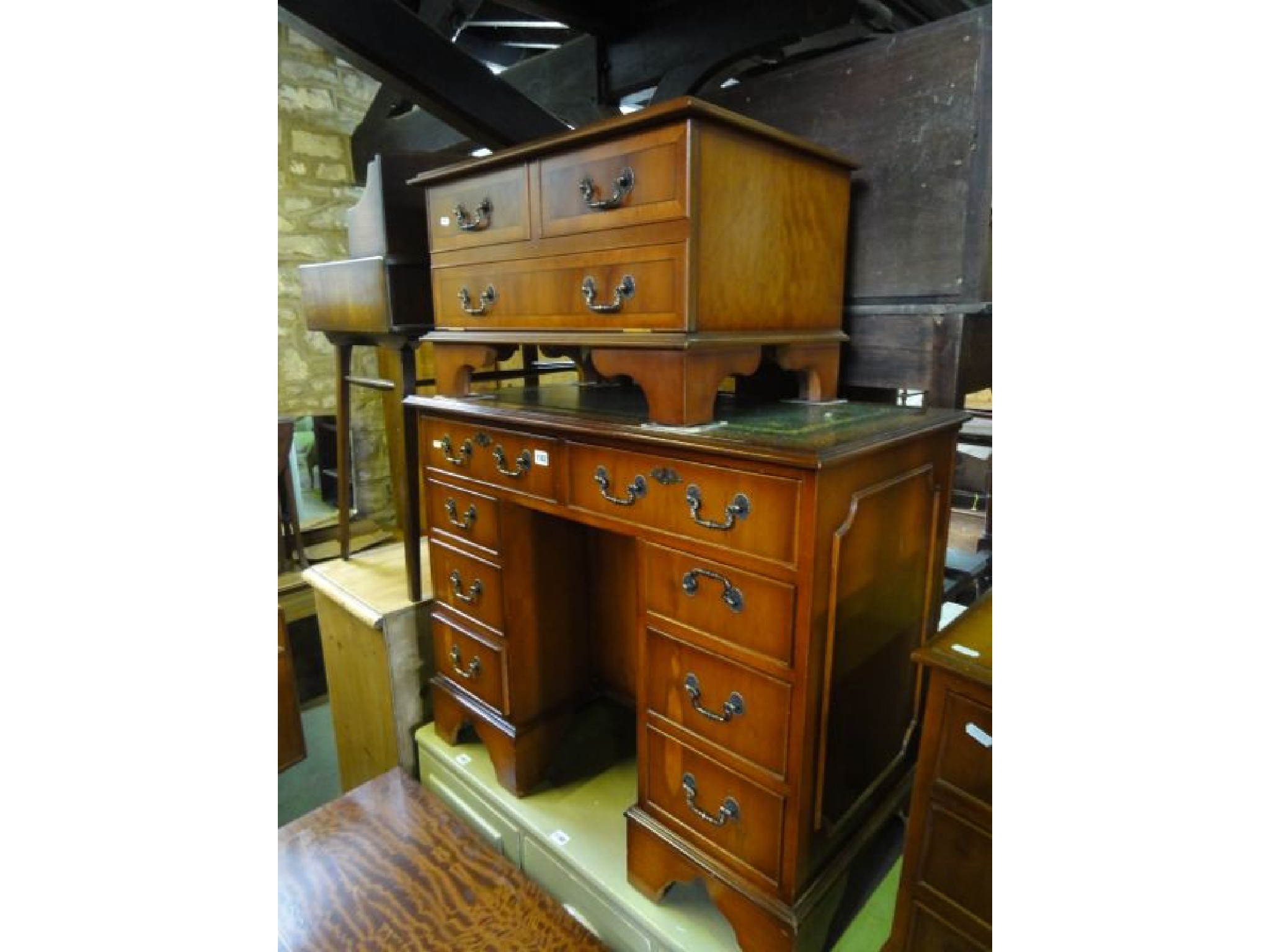 Appraisal: A reproduction yew wood veneered kneehole desk in the Georgian