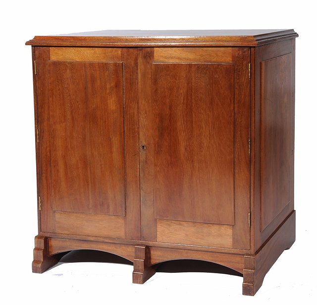 Appraisal: A COTSWOLD SCHOOL WALNUT SIDEBOARD in the manner of Edward