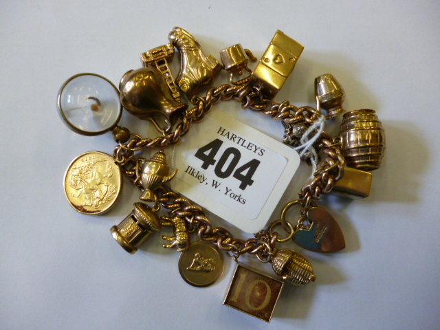 Appraisal: A CT GOLD CHARM BRACELET the flattened curb link bracelet