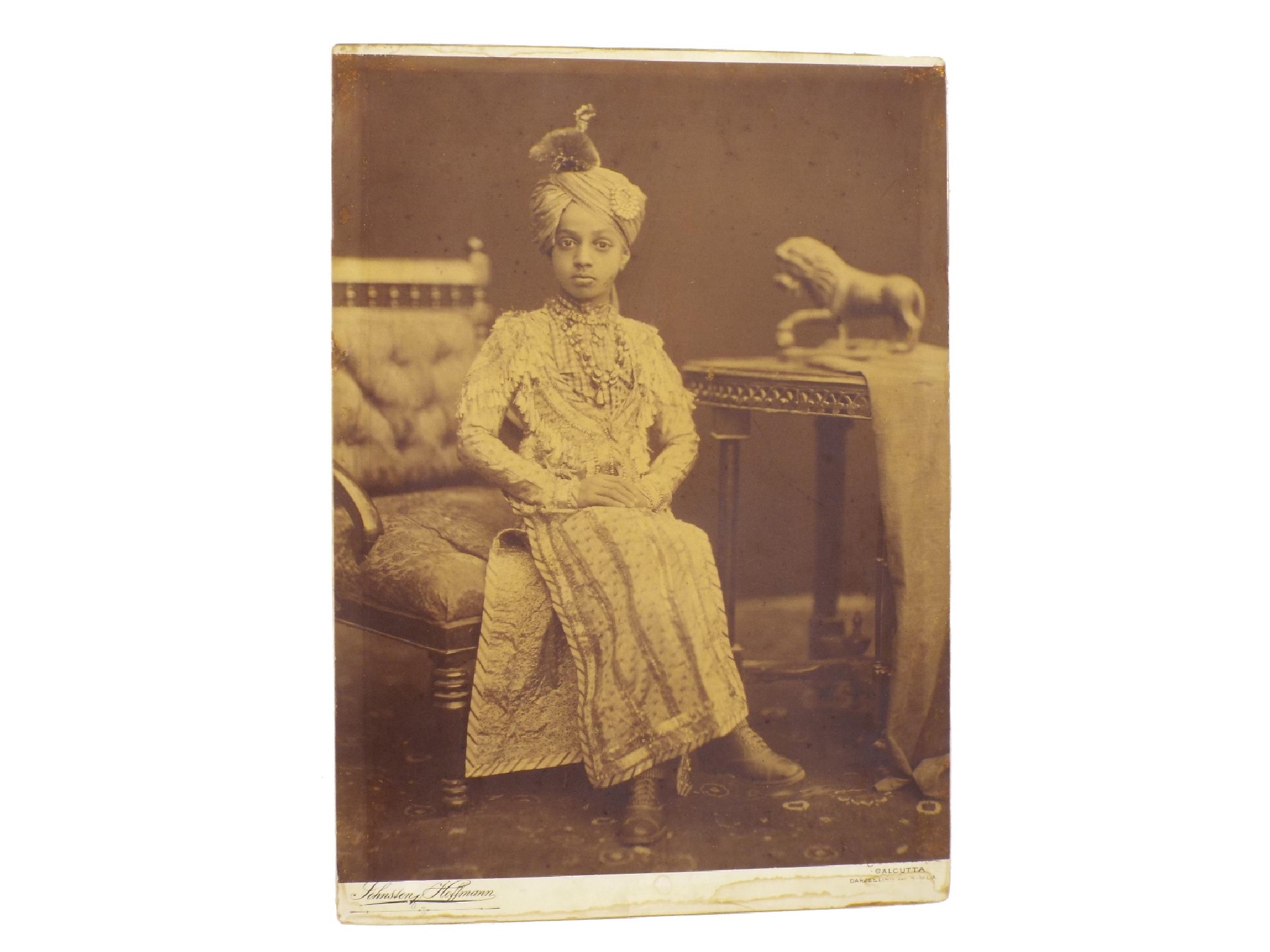 Appraisal: Large sepia photograph of a young Indian boy in traditional