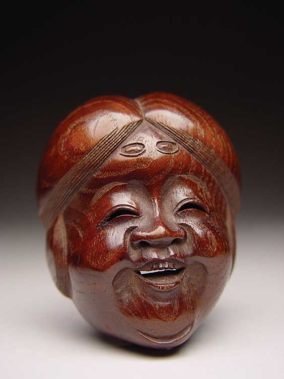 Appraisal: ANTIQUE WOOD NETSUKE Large and antique wood mask netsuke of