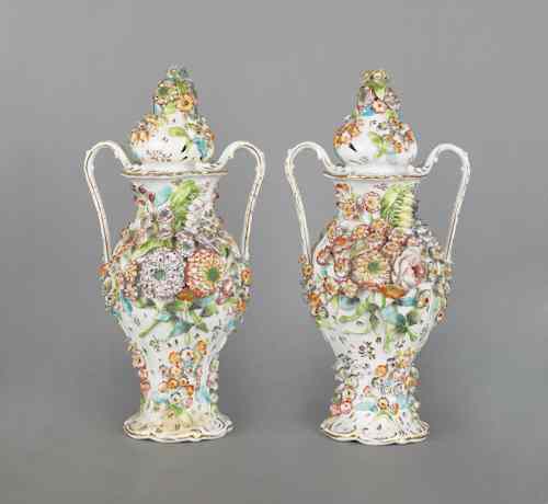 Appraisal: Pair of porcelain covered vases th c with applied floral