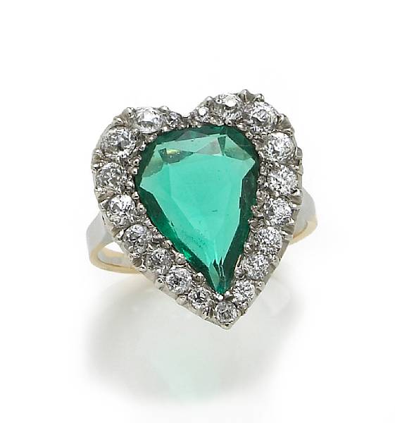 Appraisal: An emerald and diamond heart motif ring centering a pear-shaped