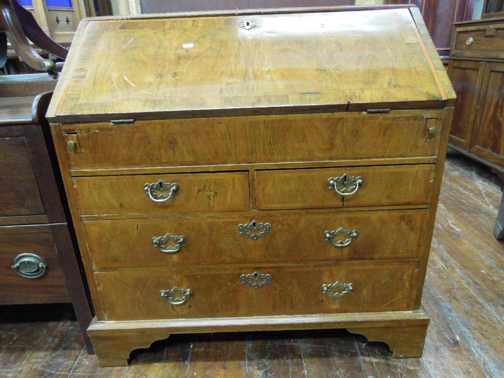 Appraisal: A Georgian walnut bureau the fall front with chevron banding