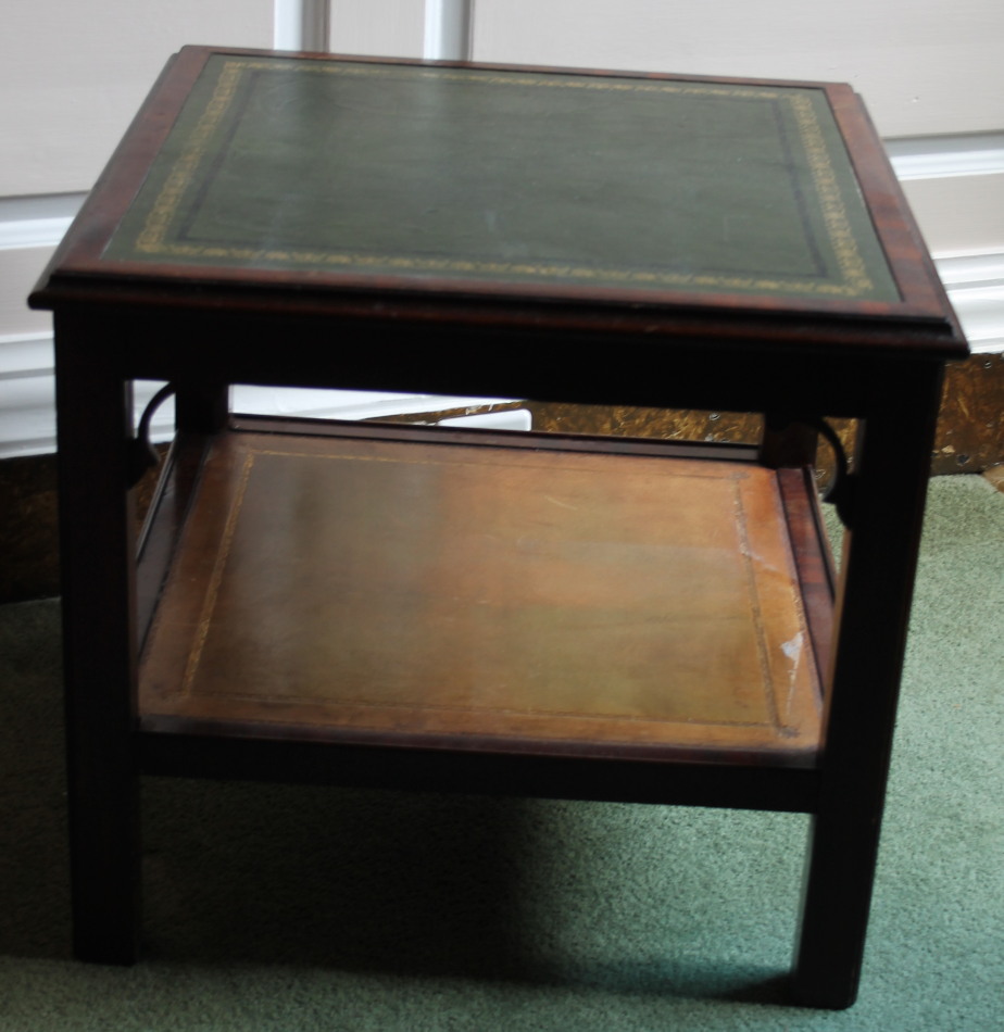 Appraisal: A mahogany two tier low table with a green leather