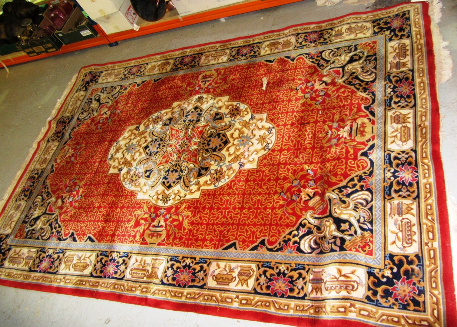 Appraisal: A modern Chinese carpet with red field ivory medallion matching