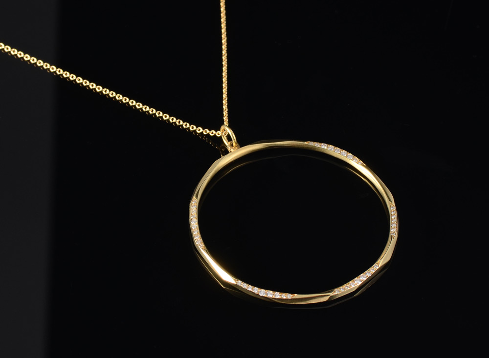 Appraisal: RON HAMI K CIRCLE DIAMOND PENDANT K yellow carved gold