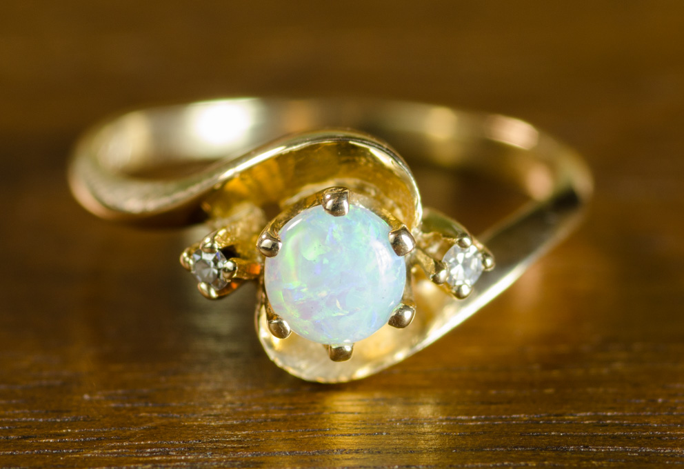 Appraisal: OPAL DIAMOND AND FOURTEEN KARAT GOLD RING with two round-cut