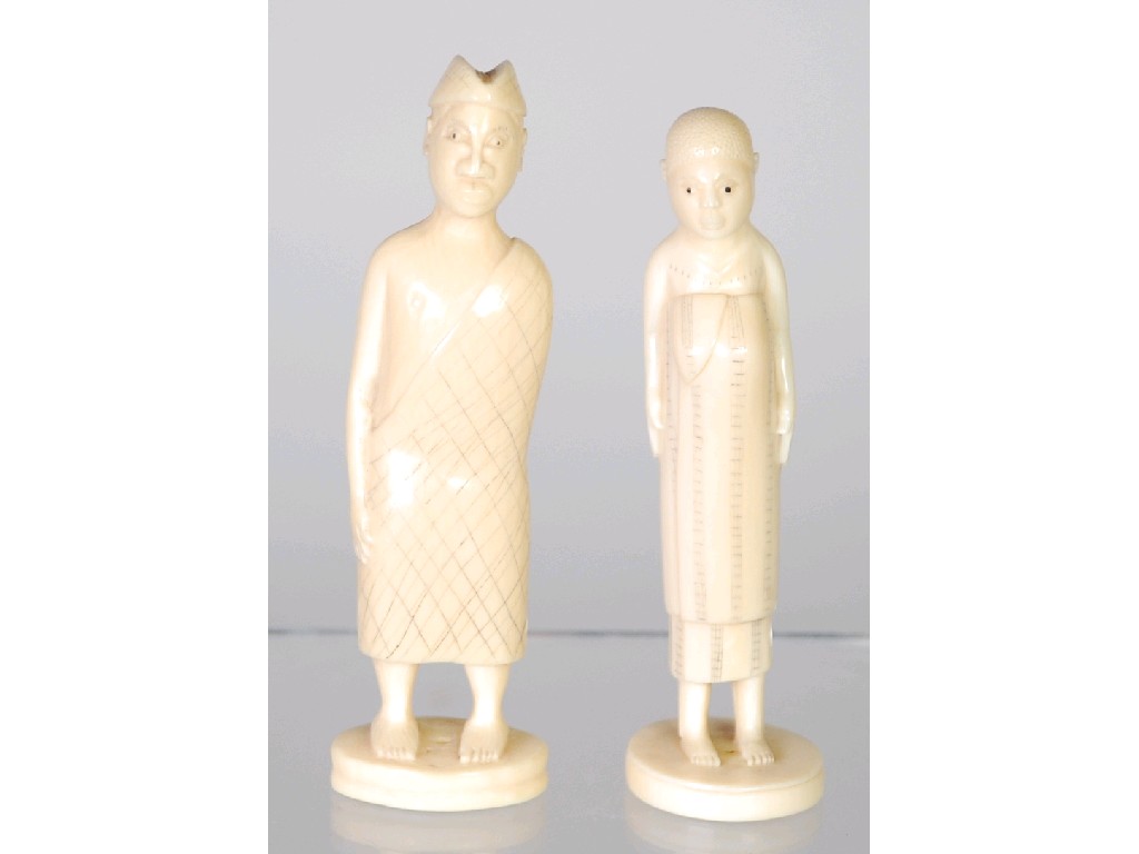 Appraisal: PAIR OF AFRICAN CARVED IVORY NATIVE FIGURES man in a