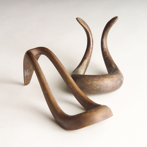 Appraisal: CARL AUBOCK Two bronze loop-shaped pipe holders with original medium