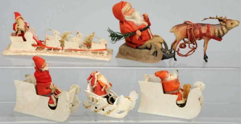 Appraisal: Lot of Santas in Sleighs Japanese All with composition faces