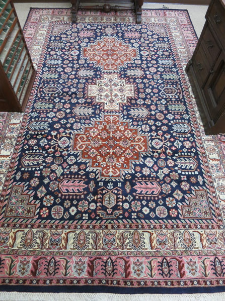 Appraisal: HAND KNOTTED ORIENTAL CARPET triple geometric medallion and stylized floral