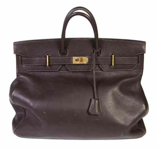 Appraisal: An Hermes Brown Leather Travel Bag with gold hardware lock