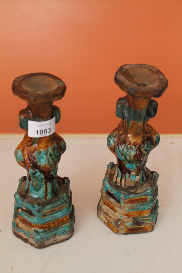 Appraisal: A pair of Chinese candlesticks with blue and orche glaze