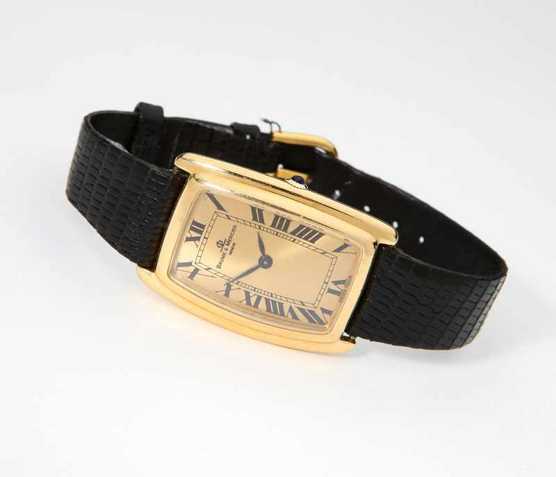 Appraisal: A champagne sunburst rectangular dial with black enamel Roman numerals