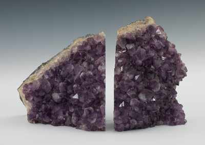 Appraisal: A Set of Large Amethyst Geode Bookends Two geode sections