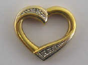 Appraisal: A yellow metal tests carat gold diamond heart pendant approx