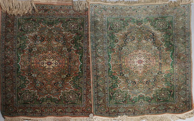 Appraisal: A PAIR OF TABRIZ APPLE GREEN AND APRICOT GROUND RUGS