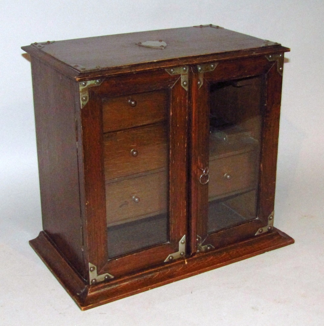 Appraisal: An early thC oak smoker's cabinet the rectangular moulded body