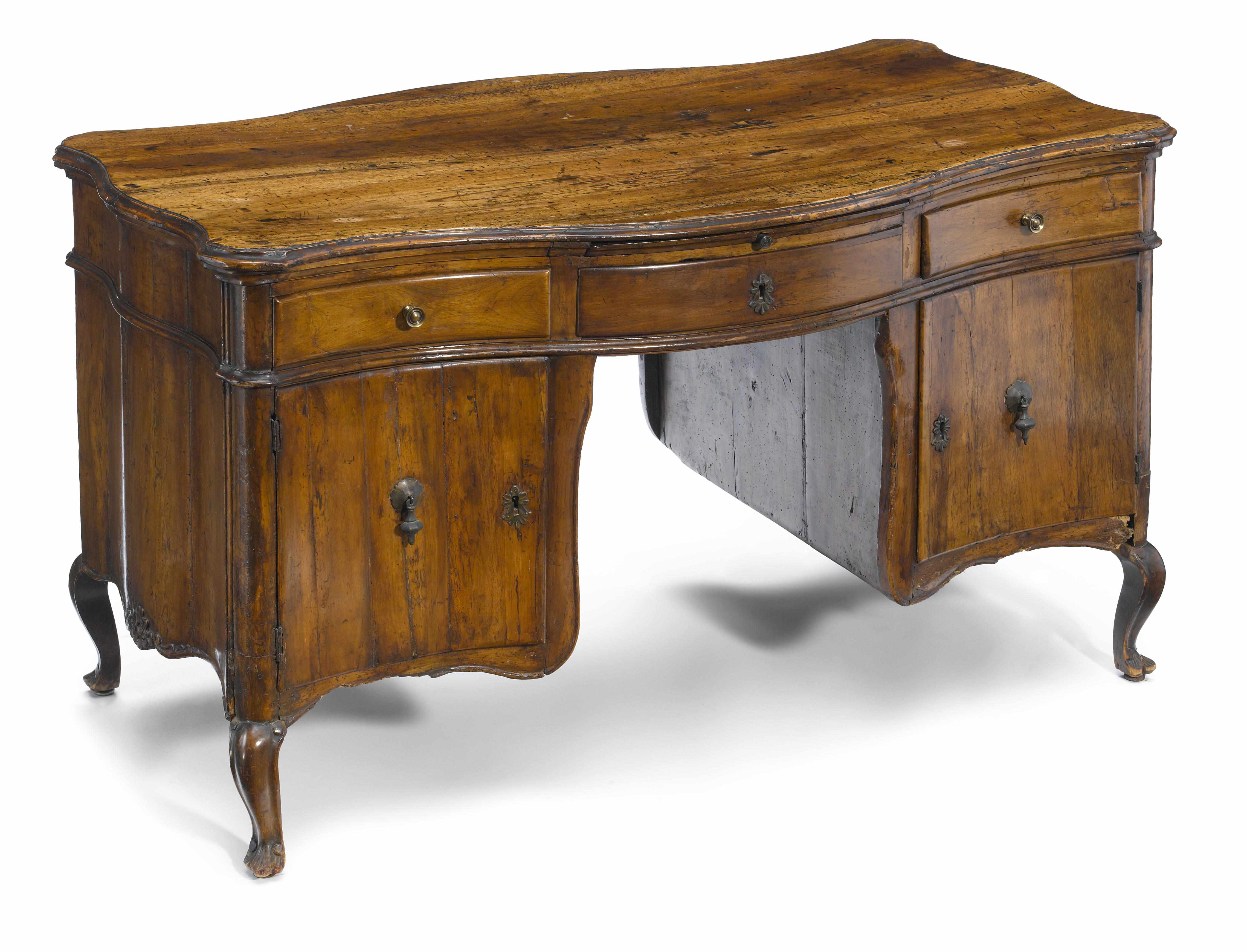 Appraisal: A Continental Rococo walnut kneehole desk probably Italian mid th