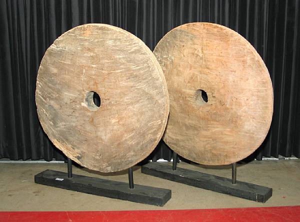 Appraisal: A pair of Asian wooden wheels Each raised on a