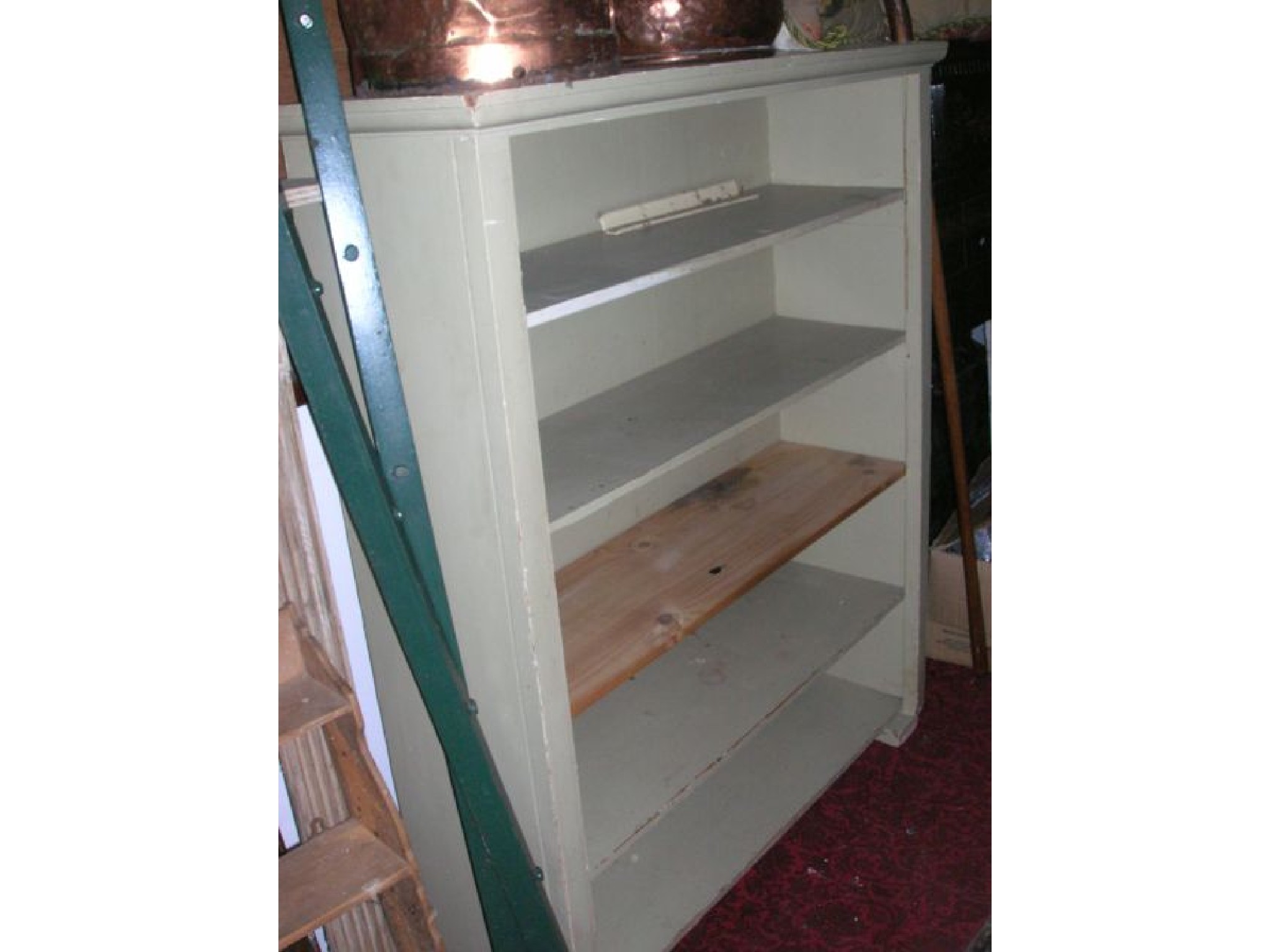 Appraisal: A painted pine freestanding open bookcase with four loose shelves