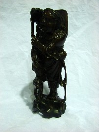 Appraisal: A carved Chinese figure of an immortal holding a dragon