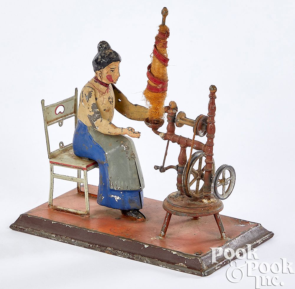 Appraisal: Gunthermann woman at spinning wheel steam toy Gunthermann painted tin