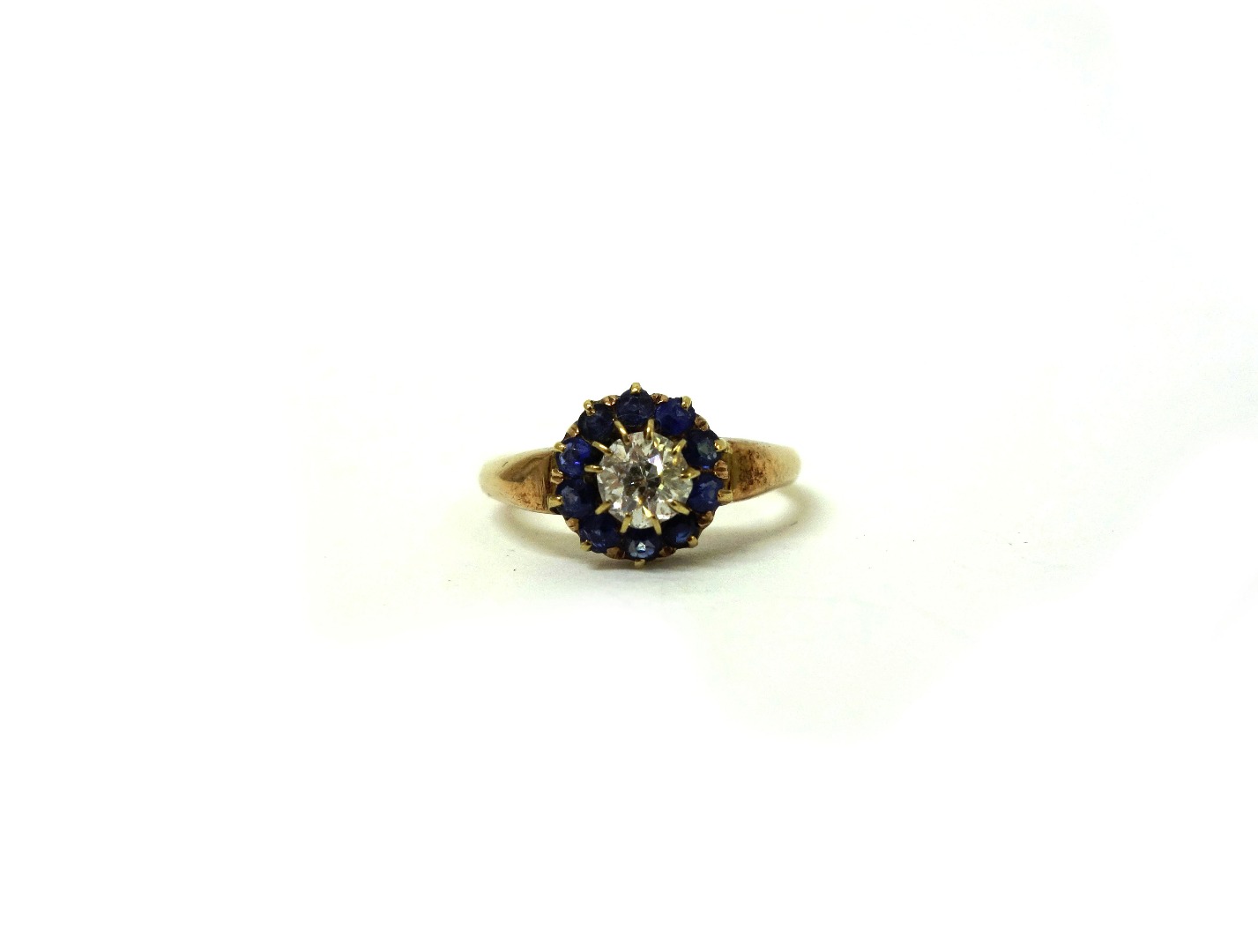 Appraisal: A yellow gold diamond and sapphire cluster ring centred by