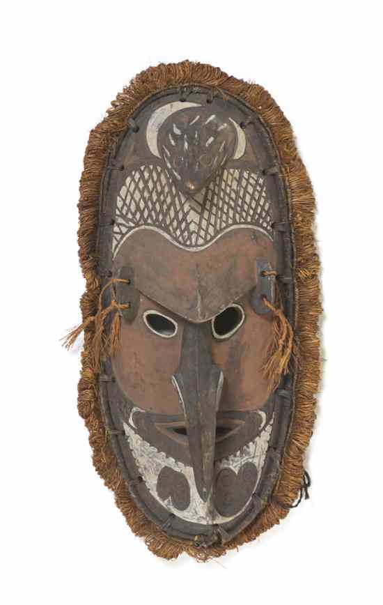 Appraisal: A Carved and Painted Wood Tiki Mask of elongated oval