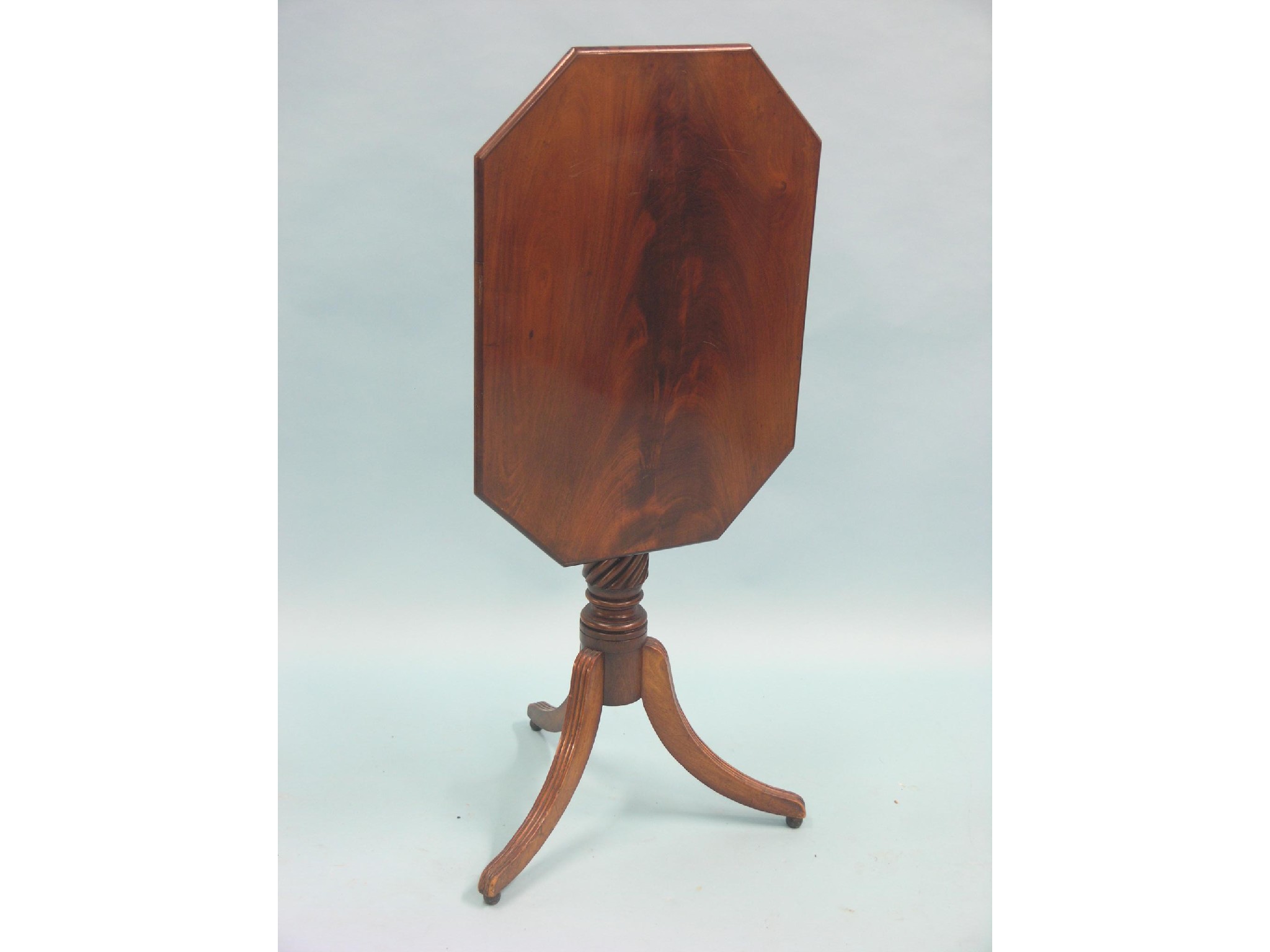 Appraisal: An early Victorian mahogany tripod table elongated octagonal top on