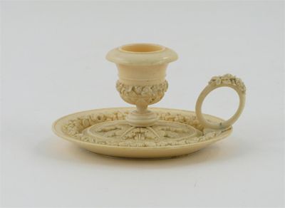 Appraisal: An ivory oval chamber stick finely carved with foliage and