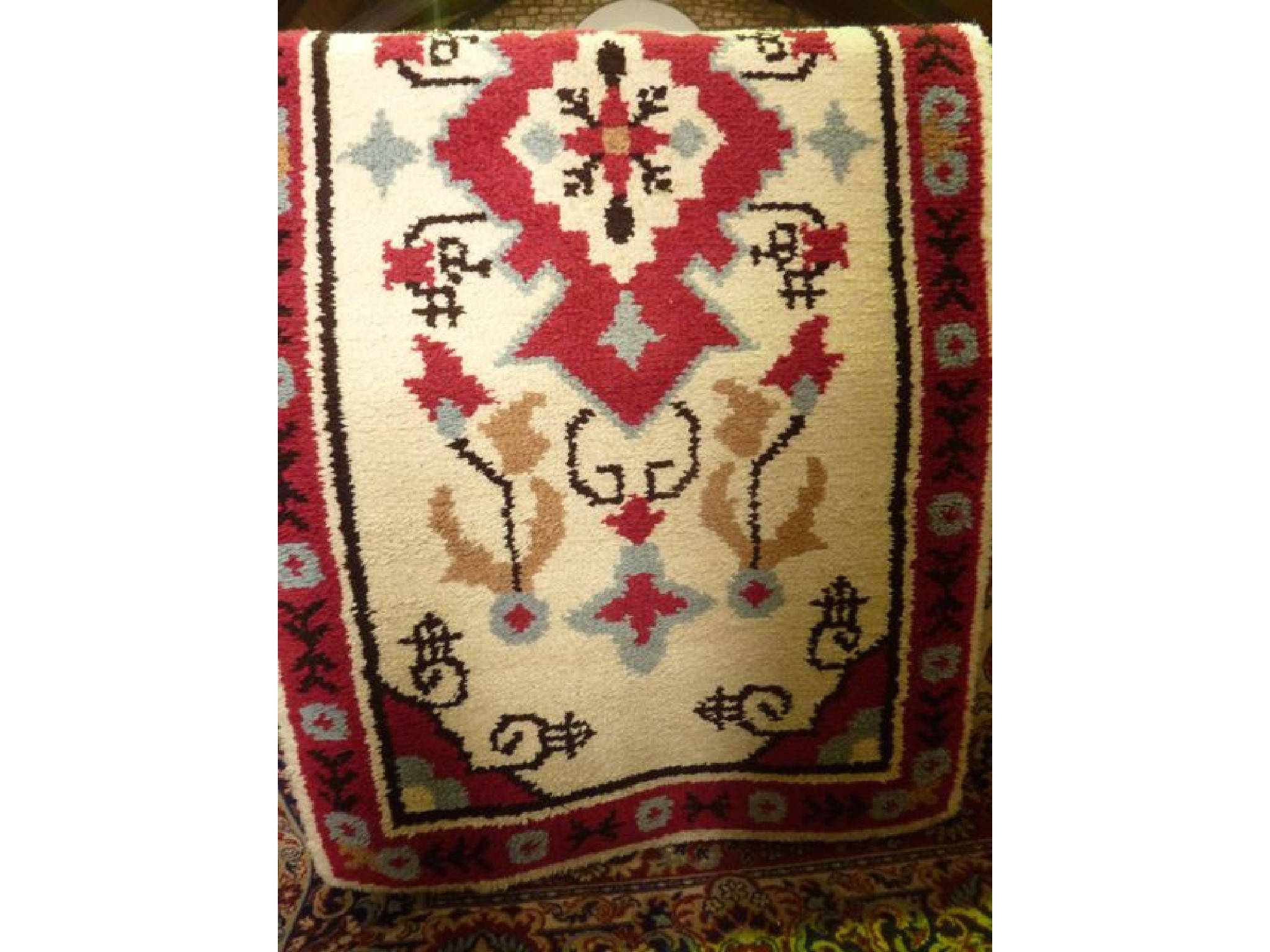 Appraisal: A Persian style wool rug with white field central medallion