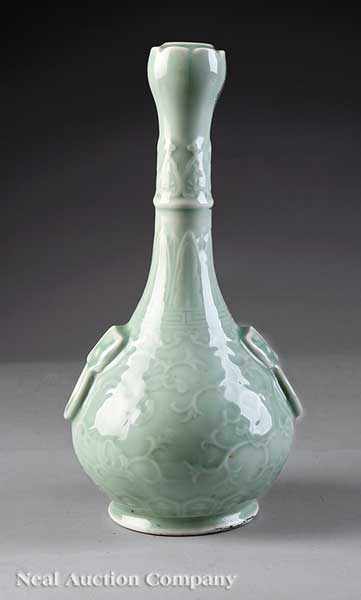 Appraisal: A Japanese Slip-Decorated Celadon Porcelain Bottle Vase the tall neck