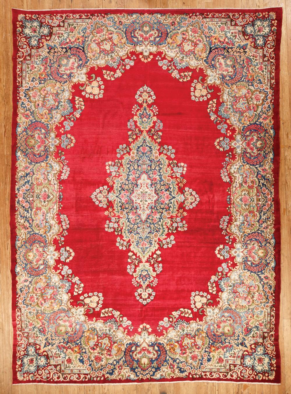 Appraisal: Persian Kerman Carpet red ground central medallion floral border ft