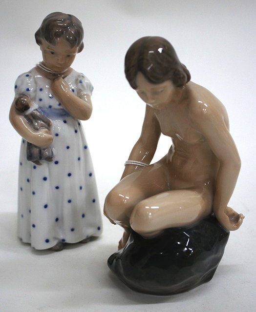 Appraisal: A ROYAL COPENHAGEN PORCELAIN FIGURE of a girl seated on