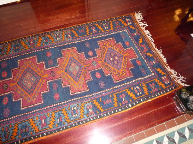 Appraisal: A PERSIAN FLOOR RUG The geometric field in colours of