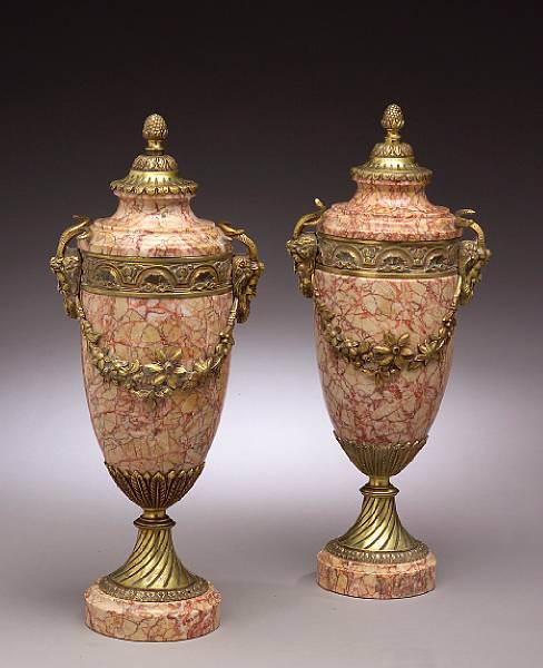 Appraisal: A pair of Neoclassical style gilt bronze mounted marble urns