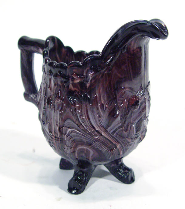 Appraisal: Sowerby style purple slag glass jug relief moulded with Scottish