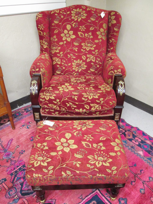 Appraisal: EMPIRE STYLE WINGBACK ARMCHAIR AND MATCHING OTTOMAN unknown maker recent