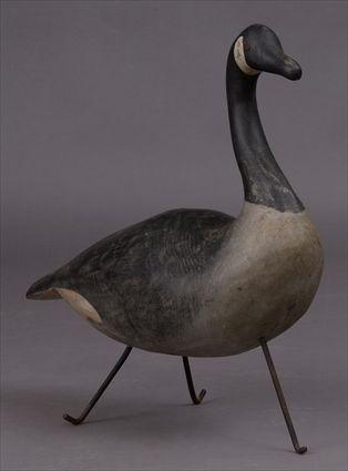 Appraisal: CARVED WOOD MODEL OF A CANADA GOOSE On wrought iron