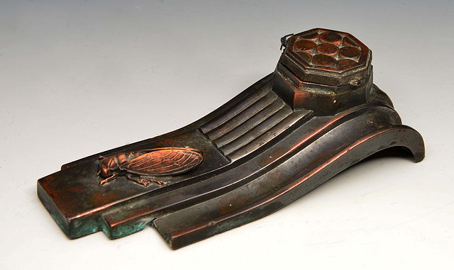 Appraisal: A FRENCH ART DECO STYLE METAL INKWELL with hinged rising