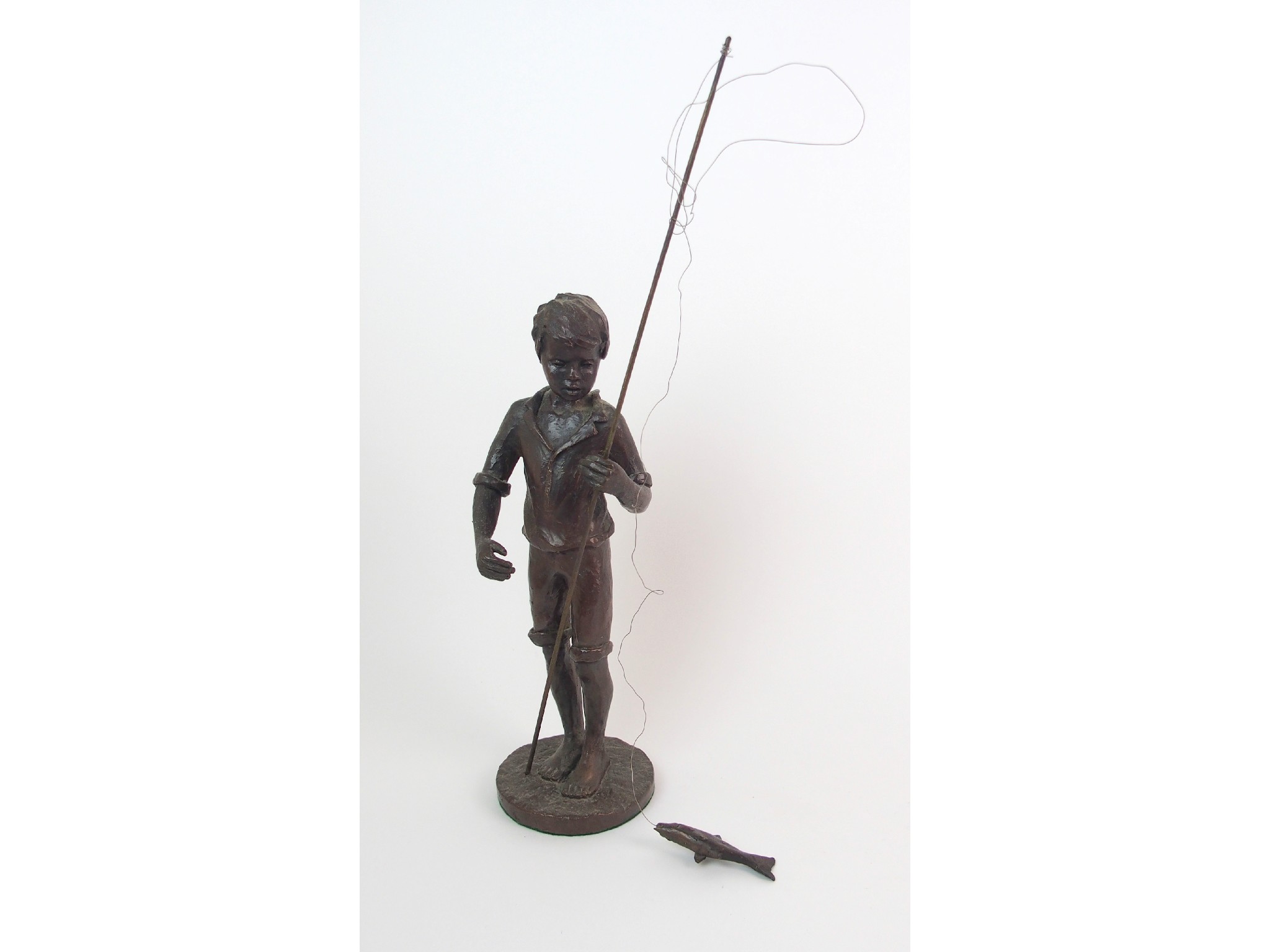 Appraisal: A patinated bronze figure of a boy fishermanmodelled as a