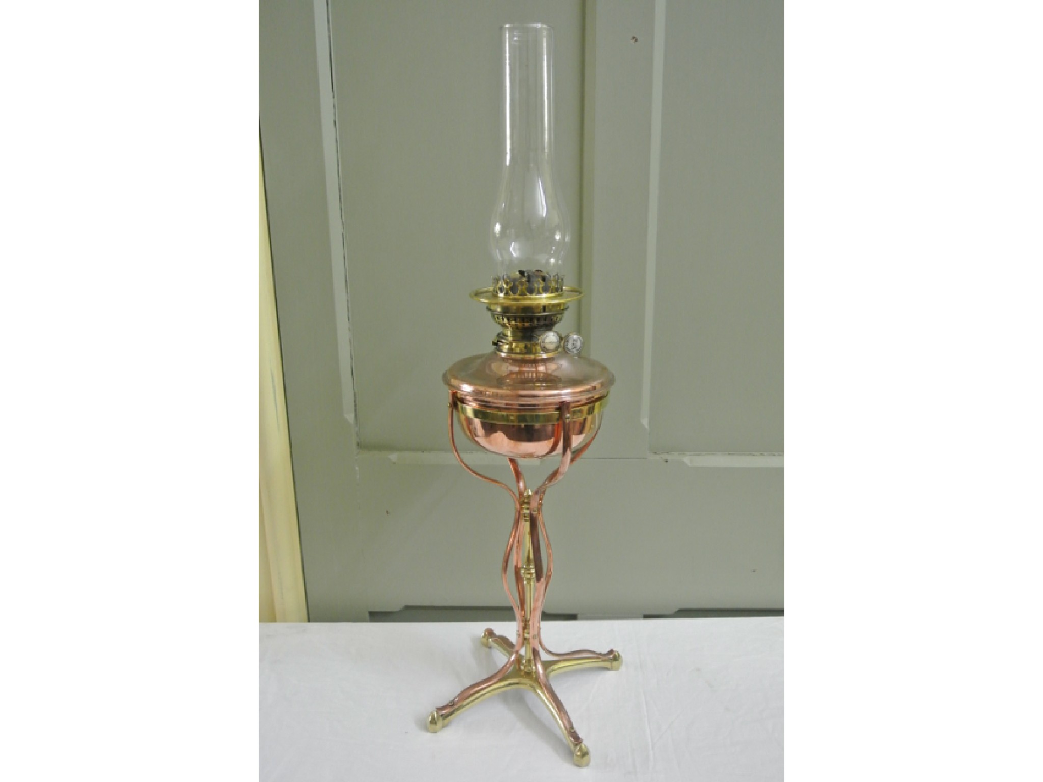 Appraisal: W A S Benson polished brass and copper oil lamp