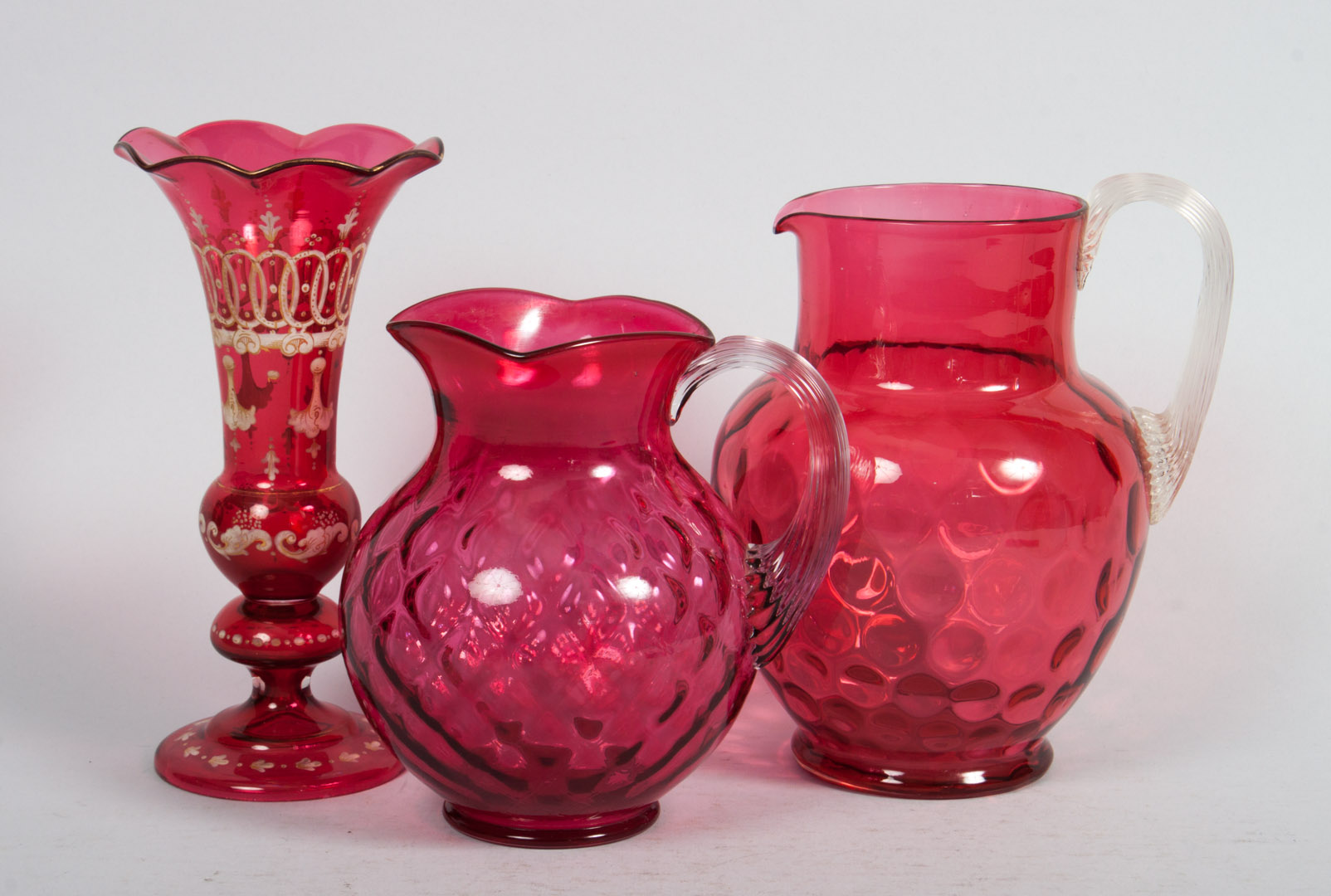 Appraisal: Three cranberry glass articles two American-made pitchers with applied glass