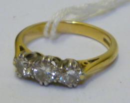 Appraisal: A THREE STONE DIAMOND RING the brilliant cut stones claw