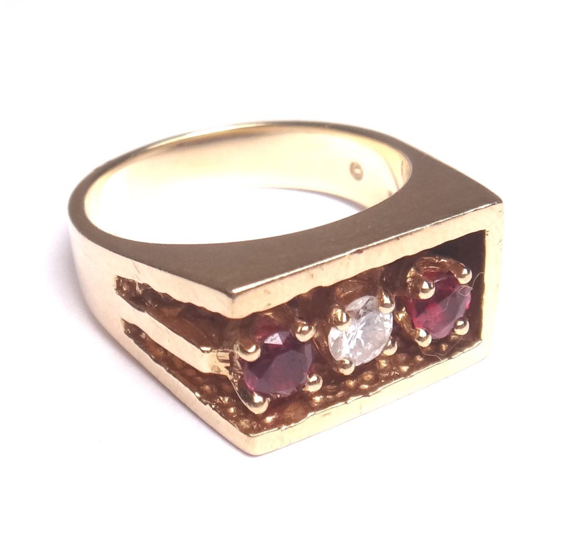 Appraisal: A gold ruby and diamond set three stone ring claw