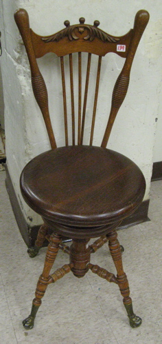 Appraisal: LATE VICTORIAN OAK CHAIR-BACK PIANO STOOL having a spindle chair